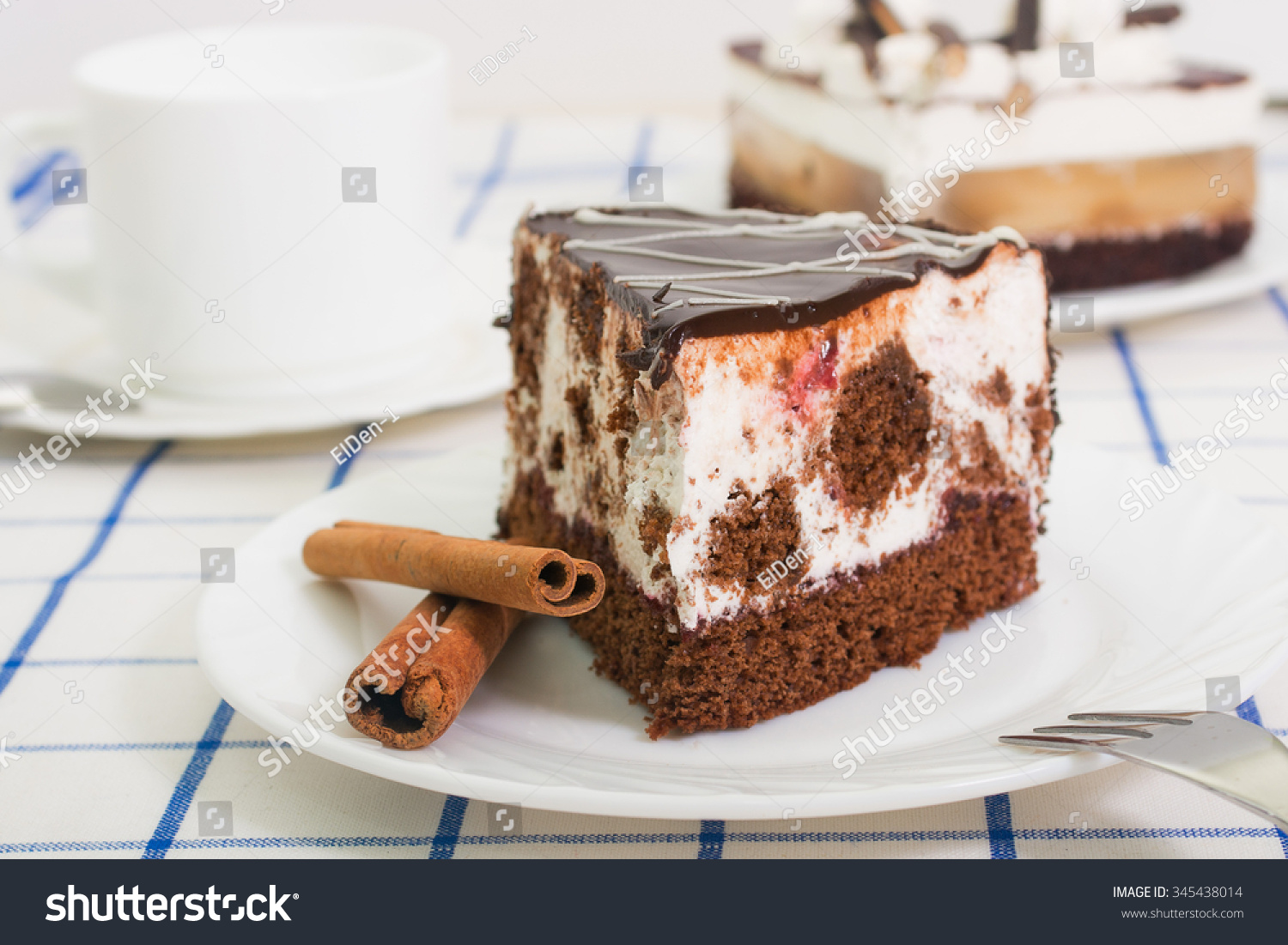 -chocolate-sponge-cake-with-a-cherry-and-air-souffle-covered-with-chocolate-icing-on-a-345438014.jpg