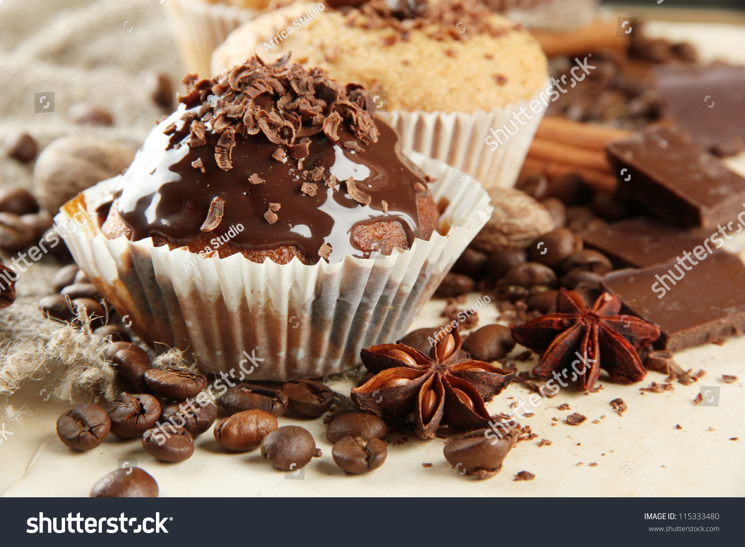 ck-photo-tasty-muffin-cakes-with-chocolate-spices-and-coffee-seeds-on-beige-background-115333480.jpg