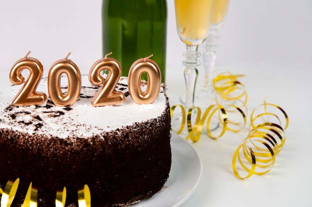 high-view-cake-and-drink-2020-digitos-ano-nuevo_23-2148347421.jpg