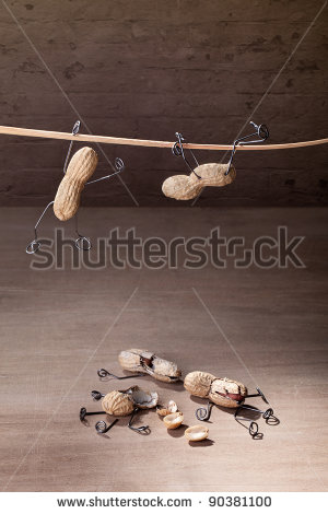 hoto-miniature-with-peanut-people-trying-to-hold-their-balance-and-grasping-for-a-straw-90381100.jpg