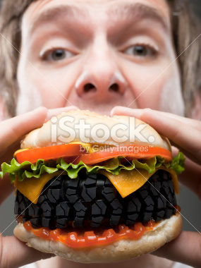 stock-photo-14633806-young-man-eating-tire-burger-studio-shot.jpg