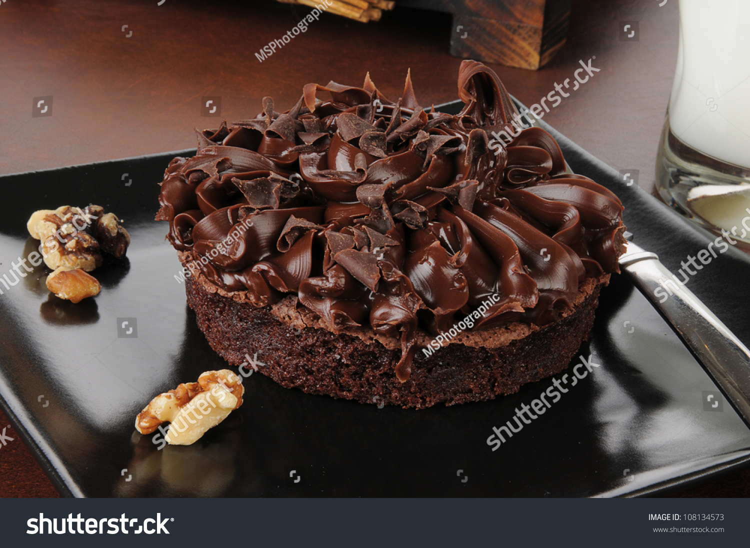 stock-photo-a-gourmet-brownie-with-walnuts-chocolate-shavings-and-milk-108134573.jpg