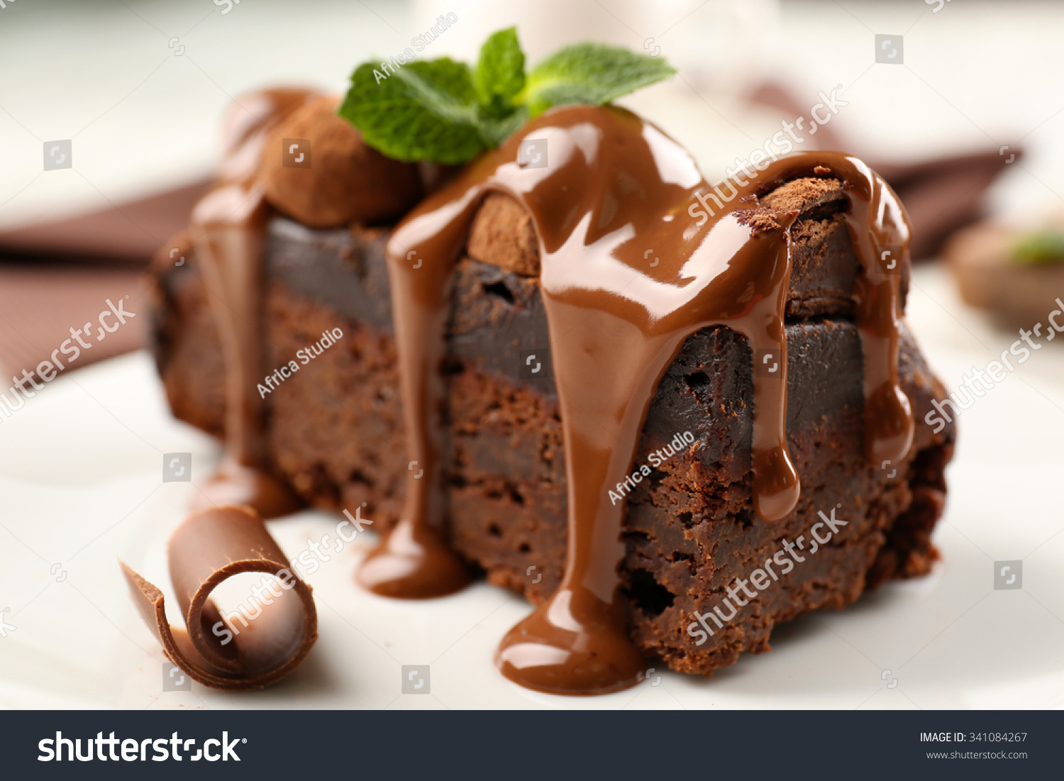 stock-photo-a-piece-of-chocolate-cake-with-mint-on-the-table-close-up-341084267.jpg