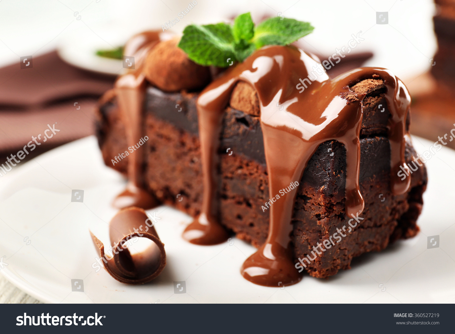 stock-photo-a-piece-of-chocolate-cake-with-mint-on-the-table-close-up-360527219.jpg