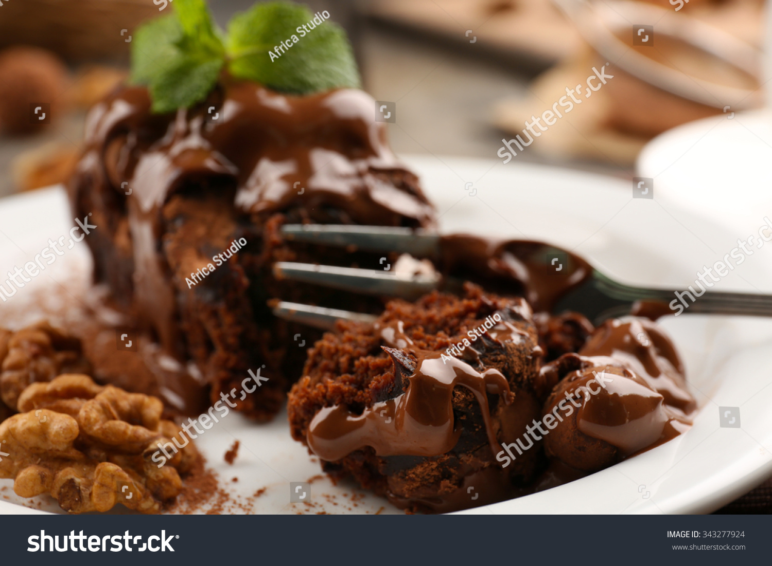 stock-photo-a-piece-of-chocolate-cake-with-walnut-and-mint-on-the-table-close-up-343277924.jpg