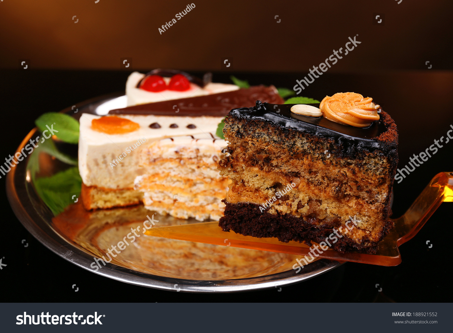 stock-photo-assortment-of-pieces-of-cake-on-dark-background-188921552.jpg