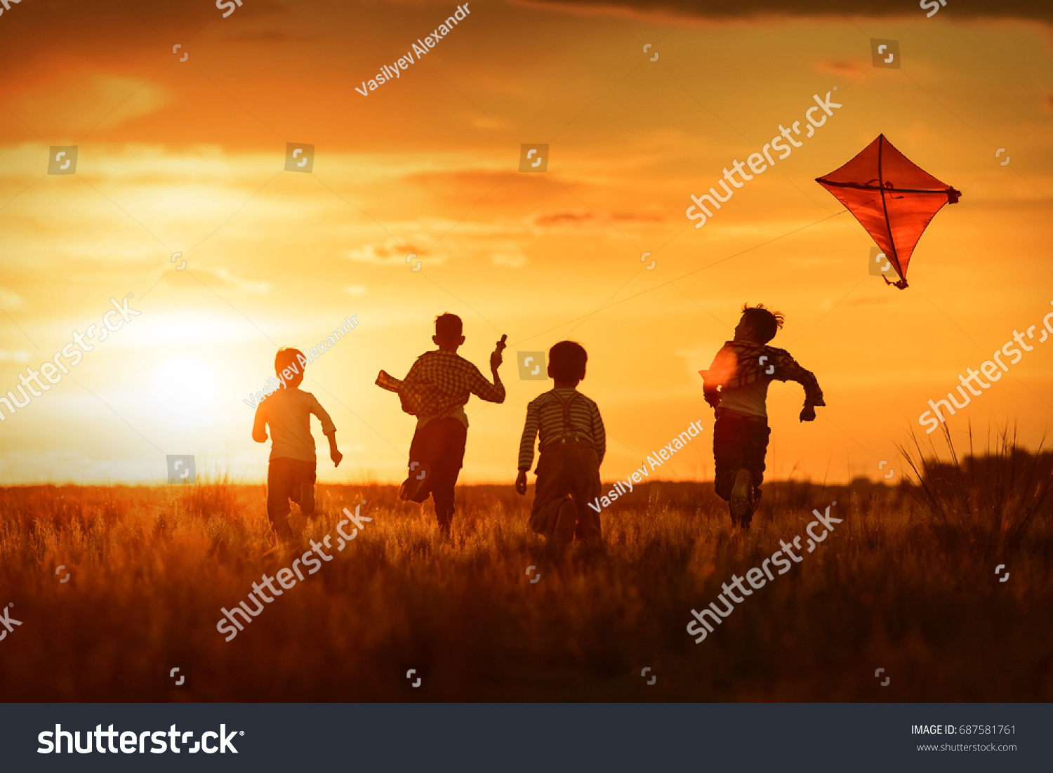 stock-photo-children-launch-a-kite-in-the-field-at-sunset-687581761.jpg