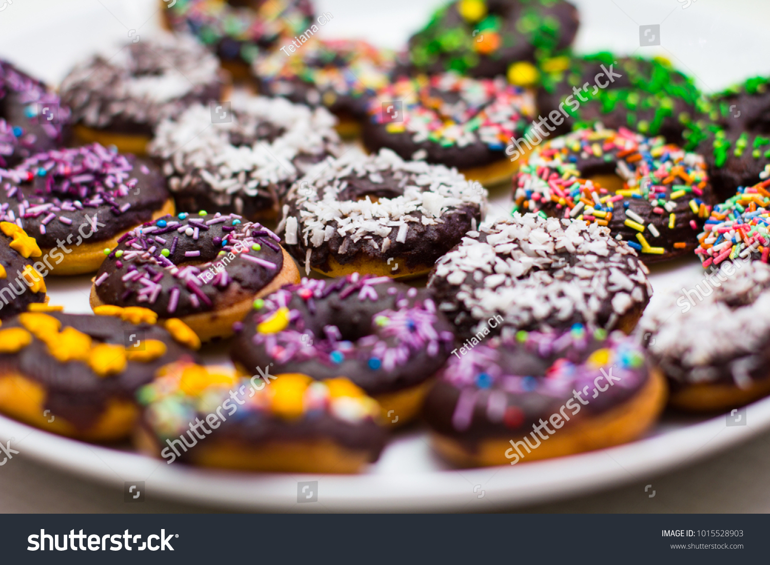 stock-photo-collection-of-many-colored-donuts-on-a-plate-1015528903.jpg