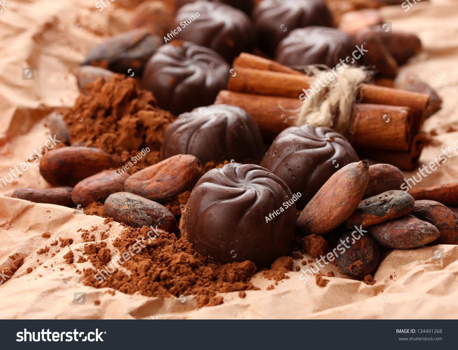 stock-photo-composition-of-chocolate-sweets-cocoa-and-spices-on-brown-background-134491268.jpg