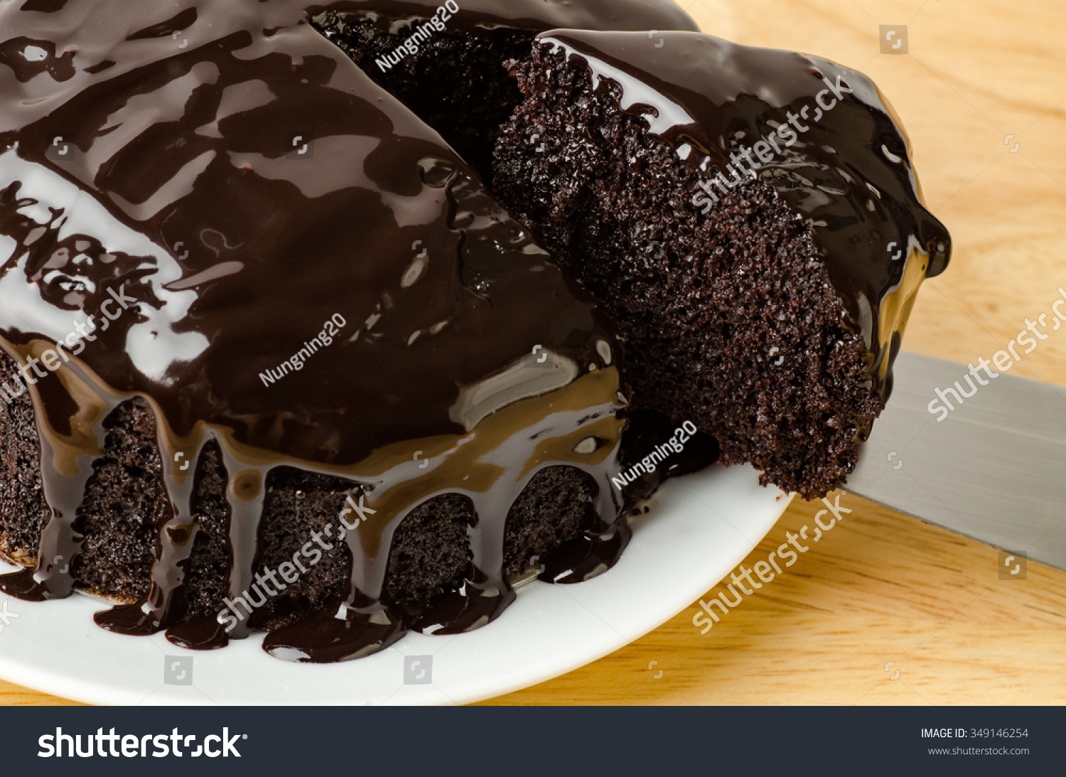 stock-photo-cutting-of-dark-chocolate-cake-on-plate-349146254.jpg