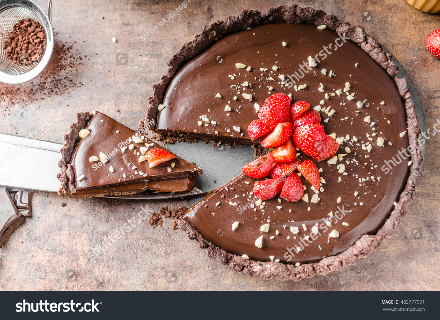 stock-photo-delicious-caramel-chocolate-tart-topped-with-nuts-and-strawberries-483777991.jpg