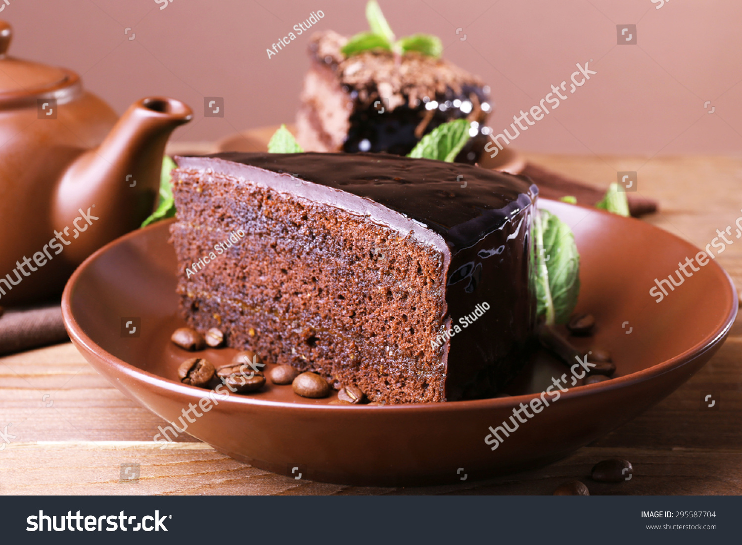 stock-photo-delicious-chocolate-cake-with-mint-on-plate-on-table-close-up-295587704.jpg