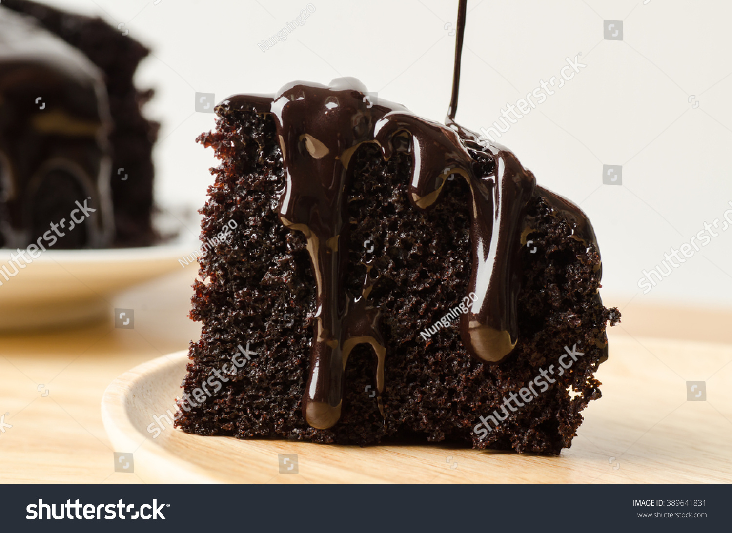 stock-photo-pouring-chocolate-sauce-on-piece-of-chocolate-cake-389641831.jpg