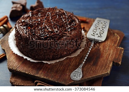 stock-photo-tasty-chocolate-cake-on-color-wooden-background-373084546.jpg
