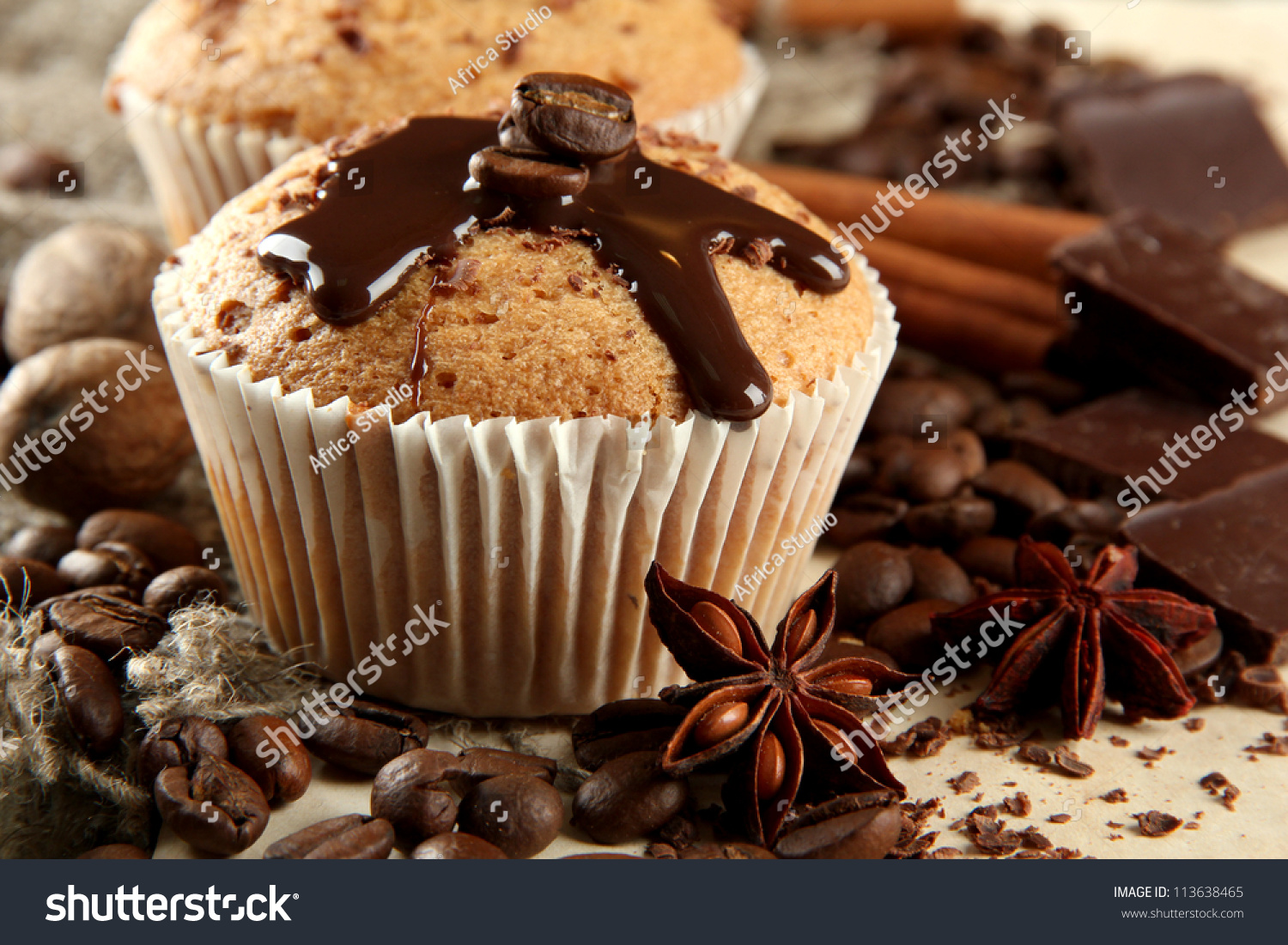 stock-photo-tasty-muffin-cakes-with-chocolate-spices-and-coffee-seeds-close-up-113638465.jpg