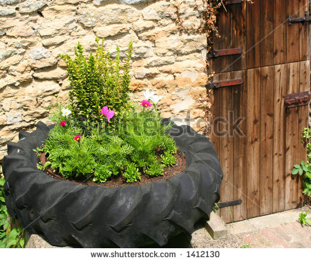 stock-photo-tire-flower-basket-with-old-barn-door-1412130.jpg