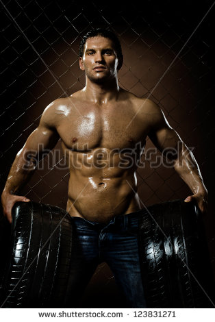 the-very-muscular-handsome-sexy-guy-with-rubber-tire-on-netting-steel-fence-background-123831271.jpg