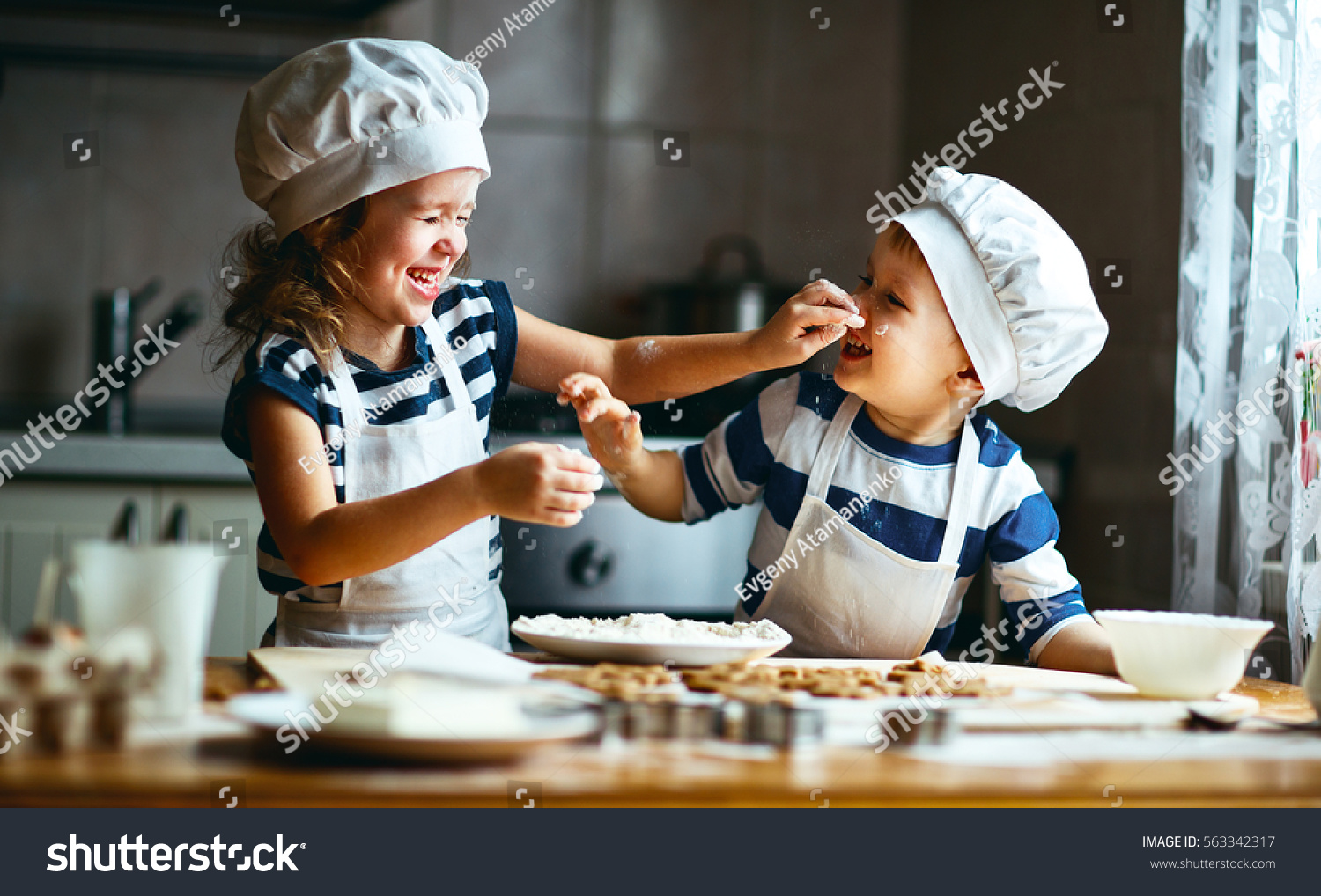 tock-photo-happy-family-funny-kids-are-preparing-the-dough-bake-cookies-in-the-kitchen-563342317.jpg